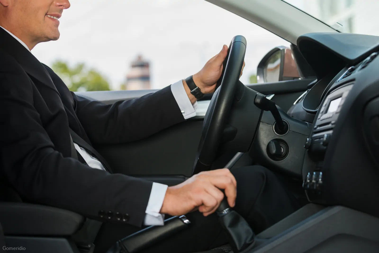 Professional chauffeur driving a premium vehicle