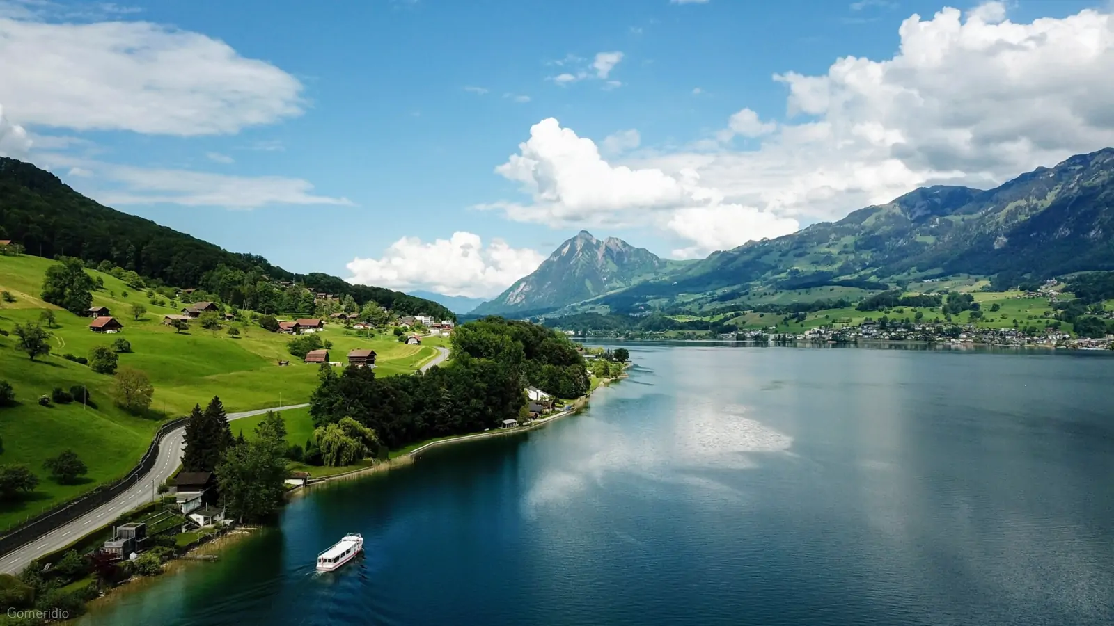Lake Lucerne with a passenger boat, green shores and mountains